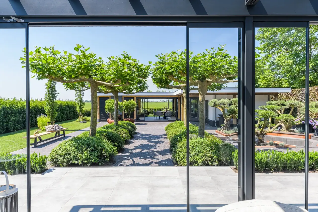 Zithoek met pergola en strakke bestrating voor beschutte buitenmomenten